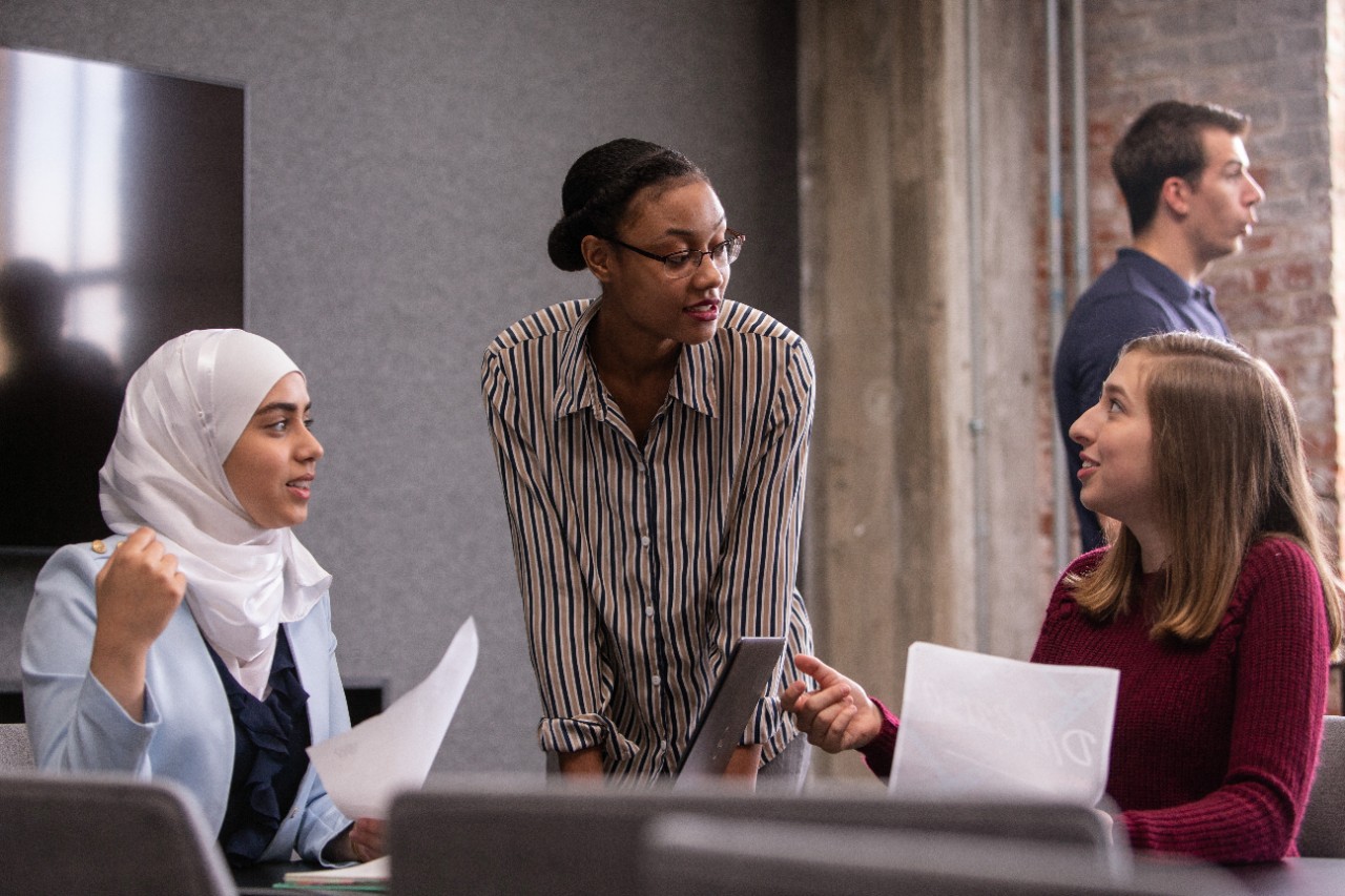 Students work in the newly renovated 1819 Innovation Hub in scenes staged for filming a UC commercial.